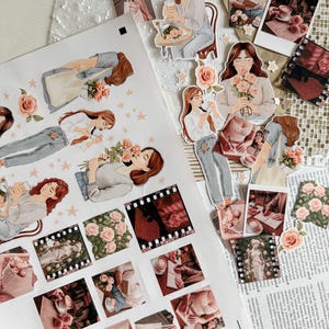 A romantic sticker sheet and cut-out elements arranged on a textured background. The sheet features watercolor-style illustrations of women holding flowers, stars, and cozy photo stickers depicting roses, books, coffee, and lace. Some stickers are already cut out and scattered nearby.
