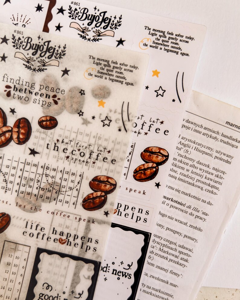May include: Assorted decorative stickers with coffee bean illustrations, text, and star accents. The stickers feature phrases like "finding peace between two sips" and "life happens coffee helps".