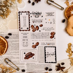 May include: A collection of coffee-themed stickers with various designs and text, including coffee beans, stars, and phrases like "finding peace between two sips." The stickers are arranged on a vintage-style background.