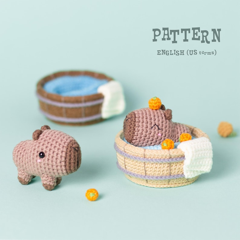 May include: Crochet pattern for a capybara in a wooden bath tub with orange slices. The pattern is written in US terms.