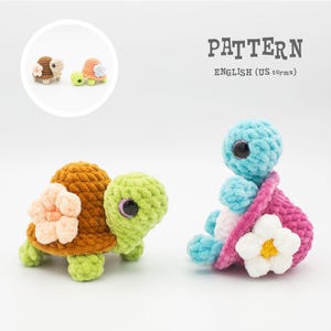 May include: Crocheted turtle toys in various colors. One turtle has a brown shell and green head, adorned with a peach flower. Another is blue with a pink shell and white flower. The image includes the text "PATTERN ENGLISH (US terms)".
