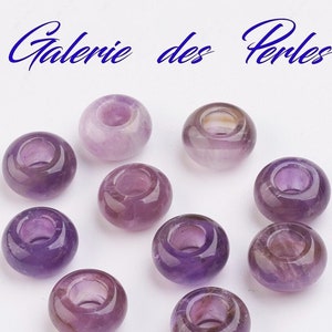 Peut inclure: Dix perles en améthyste avec un trou au centre. Les perles sont de couleur violet clair et ont une finition lisse et polie.