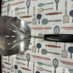 Vintage Foley curved large slotted spatula.