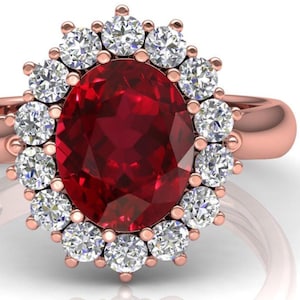 May include: Rose gold ring featuring a large, oval-cut ruby center stone surrounded by a halo of smaller, round diamonds. The ring's band is a smooth, polished rose gold. The ruby is a deep, rich red color.