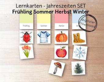 May include: A set of 12 colorful flashcards featuring illustrations of different seasons. The cards include images of a ladybug, tulips, a striped shirt, a pumpkin, an apple, a snowflake, a mushroom, and a pine tree. The cards are labeled with the German words for each season: Frühling (Spring), Sommer (Summer), Herbst (Autumn), and Winter.