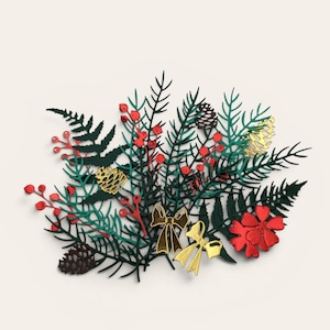 May include: A decorative flat metal cutout featuring a festive arrangement of dark green pine branches and fern fronds. The design includes small red berries, two gold-colored bows, a red flower, and two pinecones in brown and gold metallic finishes.