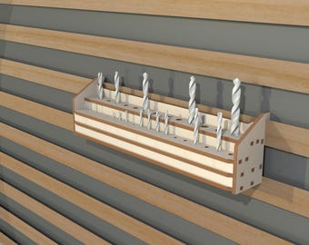 May include: A wooden drill bit organizer with multiple slots for storing drill bits. The organizer is mounted on a wall and has a light wood finish.
