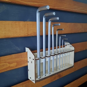 May include: A wooden wall-mounted organiser with a set of silver Allen keys. The organiser has slots for each key and is designed to keep them organised and easily accessible.