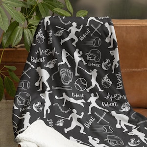 May include: Black and white baseball themed fleece blanket with the name "Robert" repeated throughout the design.