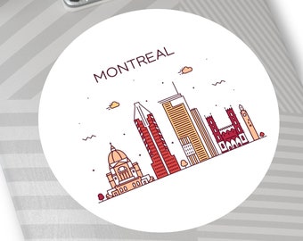 May include: A white circle sticker with a red outline and the word "MONTREAL" in red text. The sticker features a line drawing of the Montreal skyline in red, orange, and brown.