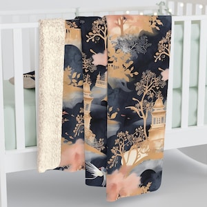 May include: A soft, plush throw blanket with a navy blue background and a gold and peach watercolour design of a Japanese garden. The blanket features a repeating pattern of trees, pagodas, and birds.