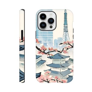 May include: A white phone case with a watercolor illustration of a Japanese cityscape. The illustration features a tower, buildings, and cherry blossoms.