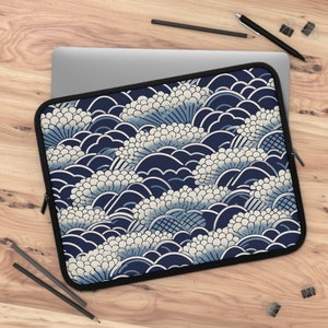 May include: A blue and white laptop sleeve with a Japanese-inspired wave pattern. The sleeve has a zipper closure and a soft, padded interior to protect your laptop.