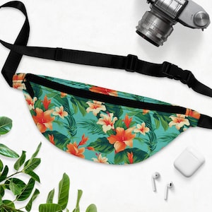 May include: A black fanny pack with a tropical floral print featuring orange hibiscus flowers and green leaves on a turquoise background.