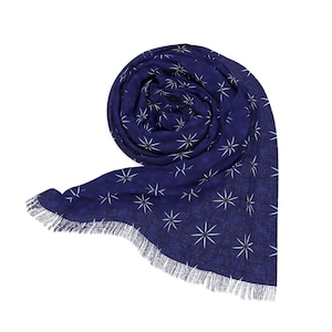 May include: A navy blue scarf with a white star pattern and fringed edges.