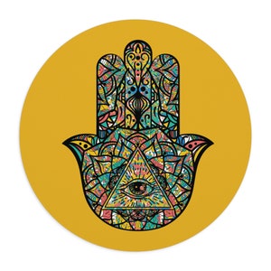 May include: A colorful hamsa hand with an all-seeing eye in the center, on a yellow background.