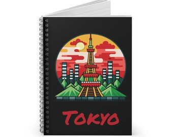 May include: A black spiral notebook with a colorful illustration of the Tokyo Tower in front of a red and orange sunset. The text "TOKYO" is written in red at the bottom of the notebook.