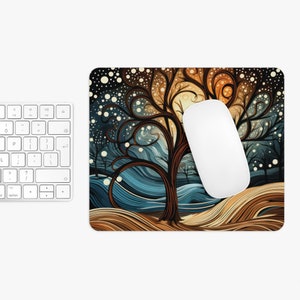 May include: A mouse pad with a whimsical design featuring a stylized tree with swirling branches and a blue and brown background. The tree is surrounded by white dots, resembling snow.