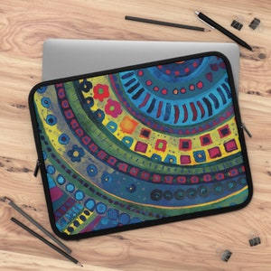May include: A laptop sleeve with a colorful, abstract design featuring circles, squares, and flowers. The design is in shades of blue, green, yellow, red, and orange.