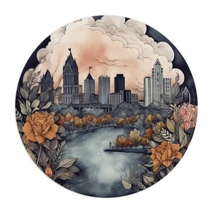 May include: A watercolor illustration of a cityscape with buildings in the background and a lake in the foreground. The buildings are painted in shades of gray and brown, and the lake is a deep blue. The foreground is filled with lush green foliage and orange flowers.