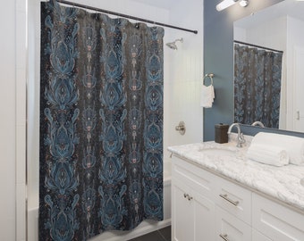 May include: A blue and black shower curtain with a floral pattern. The curtain is hanging in a bathroom with a white vanity and a white tiled shower.