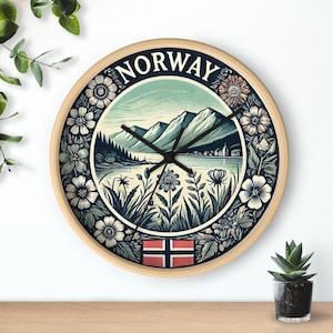 May include: A round wooden wall clock with a blue and green design featuring a mountain landscape, a lake, and a floral border. The clock face says "NORWAY" and includes the Norwegian flag.