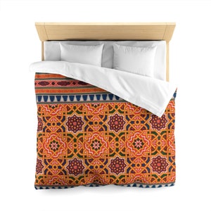 May include: A duvet cover with a geometric pattern in shades of orange, yellow, green, blue, and red. The pattern features intricate details and a repeating design.