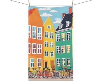 May include: A colorful illustration of a row of colorful houses with bicycles parked in front of them. The houses are yellow, orange, and green with white windows. The bicycles are red, blue, and yellow.