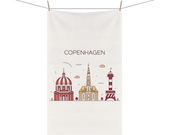 May include: White towel with a line drawing of Copenhagen landmarks in red, yellow, and brown. The word "COPENHAGEN" is printed in brown above the illustration. The towel is hanging from a clothesline.