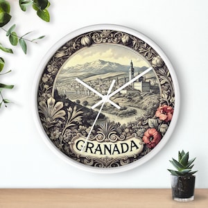May include: White round clock with a black and white image of the city of Granada, Spain. The clock face has a black and white floral design with the word "Granada" in black lettering at the bottom.
