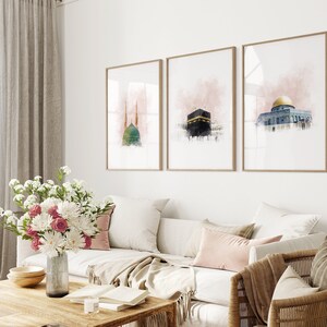 May include: Three framed watercolor paintings of Islamic architecture. The paintings are in a living room setting with a couch, coffee table, and a chair.