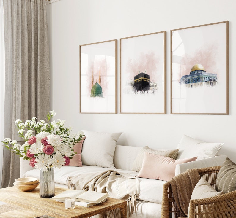 May include: Three framed watercolor paintings of Islamic architecture. The paintings are in a living room setting with a couch, coffee table, and a chair.