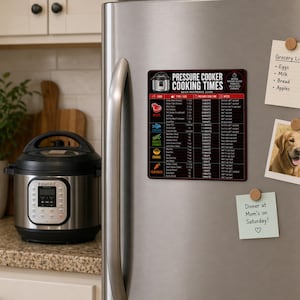 May include: A black and red magnetic sign with "PRESSURE COOKER COOKING TIMES" text is attached to a stainless steel refrigerator. The sign lists cooking times for various foods. A photo of a golden retriever and a grocery list are also attached.
