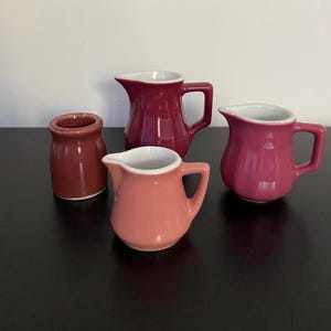 Instant collection of 4 mauve/maroon/rose restaurant ware creamers by Hall, Shenango and Syracuse