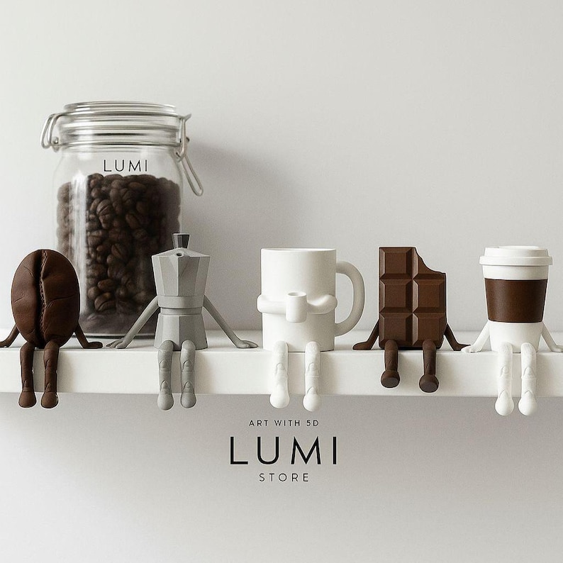May include: A collection of whimsical coffee and chocolate-themed figurines, including a coffee bean, a stovetop espresso maker, a mug, a chocolate bar, and a coffee cup. A glass jar filled with coffee beans is also present. The word "LUMI" is visible.