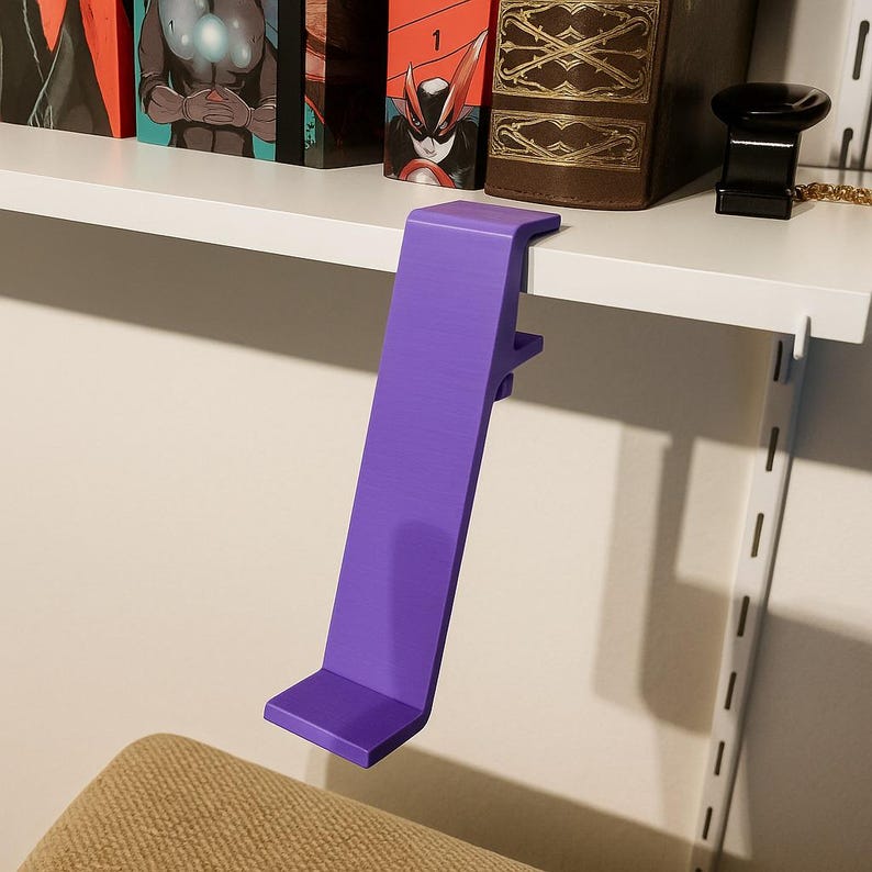 May include: A vibrant purple shelf clip, designed to attach to a shelf. The clip is made of a solid material and has a rectangular shape with a right-angle bend at the top and bottom. It is designed to hold items on a shelf.