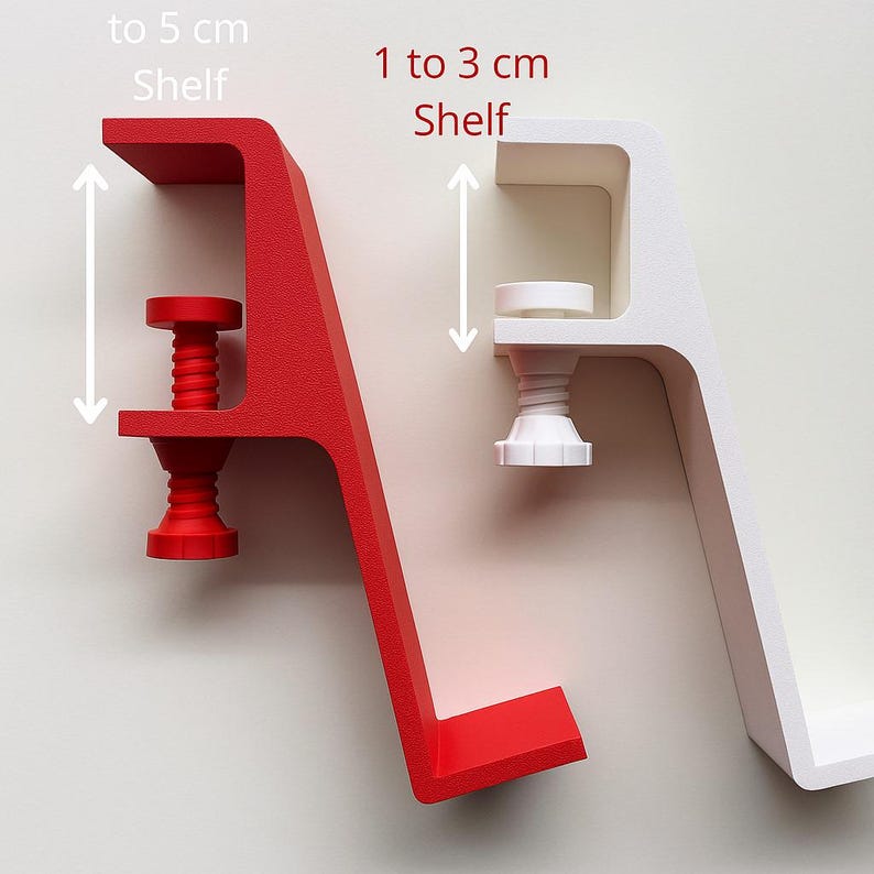May include: Two clamp-style shelves, one red and one white, are displayed against a neutral background. The red shelf is designed for shelves up to 5 cm, while the white shelf accommodates shelves from 1 to 3 cm. Text indicates shelf size.