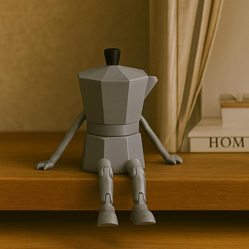 May include: A gray, anthropomorphic coffee maker figurine with arms and legs, sitting on a wooden shelf. The coffee maker has a black top and a spout. The figurine is a whimsical decorative item.