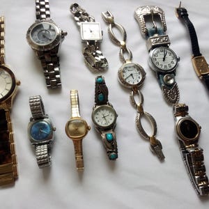 May include: A collection of ten wristwatches with various styles and designs. The watches feature different colored bands, face designs, and metal finishes.