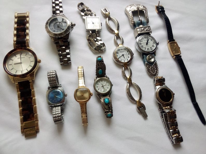 May include: A collection of ten wristwatches with various styles and designs. The watches feature different colored bands, face designs, and metal finishes.