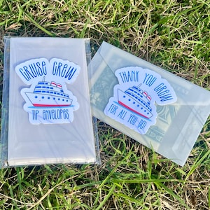 May include: Clear tip envelopes with cruise ship stickers. One sticker reads "Cruise Crew Tip Envelopes". The other sticker reads "Thank You Crew For All You Do!" The envelopes are on a bed of green grass.