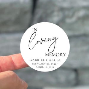 May include: White round sticker with black text that reads "In loving memory Gabriel Garcia February 26, 1944 - April 12, 2024"
