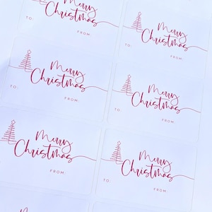 May include: Rectangular white gift tags with a red script that says "Merry Christmas". Each tag has a line drawing of a Christmas tree and space to write "To:" and "From:" in red. The tags are arranged in a grid.