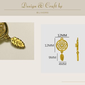 May include: Gold-colored dreamcatcher charm with a feather pendant. The charm is 12mm in diameter and 12mm in height, with a 9mm feather pendant. The charm has a small crystal in the center. The text "Design & Craft by BLIXORE" is at the top.