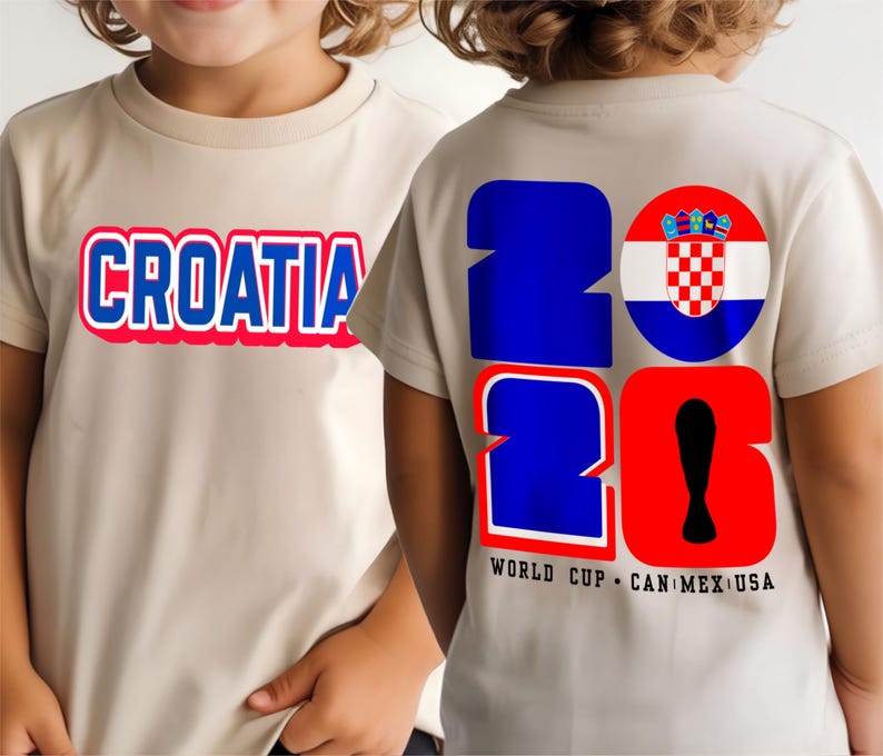 May include: Beige t-shirts with the word "CROATIA" in blue with a red outline on the front. The back of the shirt displays "2026" in blue and red, with a Croatian flag and the text "WORLD CUP CAN MEX USA".