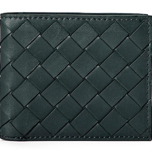May include: A dark green leather wallet with a woven pattern. The wallet is rectangular and has a stitched border. The woven design is made of interwoven strips of leather, creating a textured surface.