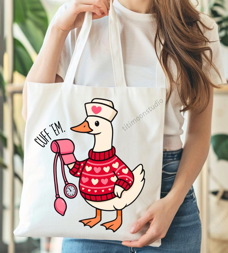 May include: White tote bag featuring a cartoon goose dressed as a nurse, wearing a red sweater with white hearts and a nurse's cap. The goose is holding a blood pressure cuff. Text on the bag reads "CUFF 'EM."