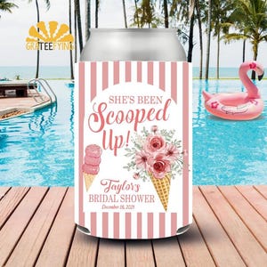 May include: A pink and white striped can cooler with the text "She's Been Scooped Up!" and "Taylor's Bridal Shower December 18, 2025". The design includes ice cream cones and floral bouquets. A pink flamingo float is in the background.