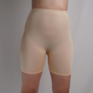 May include: A pair of nude-colored, seamless, high-waisted shorts.