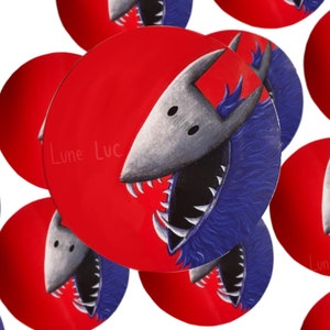 May include: A set of round stickers featuring a cartoon wolf with blue fur and sharp teeth. The wolf is on a red background with the text "Lune Luc" written in white.